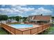 Backyard pool with wooden deck, perfect for relaxation and outdoor fun, with a residential view beyond at 139 Pleasant Garden Dr, Taylorsville, NC 28681