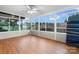 Sunroom featuring hardwood floors and a large array of windows, creating a bright and airy space at 139 Pleasant Garden Dr, Taylorsville, NC 28681
