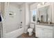 Beautiful bathroom with a shower-tub combo and vanity with a granite countertop at 1431 Hubert Graham Way, Tega Cay, SC 29708