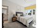 Charming bedroom with a large window, stylish decor, and ensuite bathroom access at 1431 Hubert Graham Way, Tega Cay, SC 29708