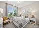 Serene bedroom with a large window, neutral tones, and comfortable furnishings at 1431 Hubert Graham Way, Tega Cay, SC 29708