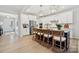 Open kitchen with stainless steel appliances, white cabinetry, and a central island with bar seating at 1431 Hubert Graham Way, Tega Cay, SC 29708