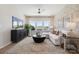 Bright living room features a modern ceiling fan and lots of natural light through large windows at 1431 Hubert Graham Way, Tega Cay, SC 29708