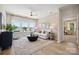 Comfortable living room boasts lots of natural light, modern decor, and stylish accents at 1431 Hubert Graham Way, Tega Cay, SC 29708