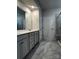 Bathroom featuring double sinks, white countertops, and a tiled walk-in shower at 147 Dubois Dr, Mooresville, NC 28115