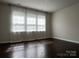 Bedroom filled with natural light streaming through the windows and decorative curtains at 147 Dubois Dr, Mooresville, NC 28115