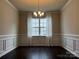 Formal dining room with elegant chandelier and dark hardwood floors at 147 Dubois Dr, Mooresville, NC 28115
