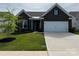 Charming brick home with well-manicured lawn, a two-car garage, and beautiful landscaping at 147 Dubois Dr, Mooresville, NC 28115
