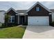 Charming brick home with a two-car garage and well-maintained lawn and front yard at 147 Dubois Dr, Mooresville, NC 28115