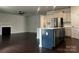 Modern kitchen features an island, stainless steel appliances, white cabinets, and hardwood floors at 147 Dubois Dr, Mooresville, NC 28115