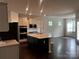 Modern kitchen with stainless steel appliances, granite countertops, and a breakfast bar at 147 Dubois Dr, Mooresville, NC 28115