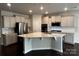 Modern kitchen with stainless steel appliances, granite countertops, and a breakfast bar at 147 Dubois Dr, Mooresville, NC 28115