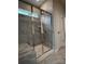 Tiled bathroom shower with glass doors, gray tile, and a built-in bench at 147 Dubois Dr, Mooresville, NC 28115