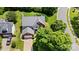 Aerial view of a well-maintained single-Gathering home with mature trees and landscaping at 16018 Hollingbourne Rd, Huntersville, NC 28078