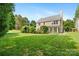 Green backyard featuring a lush lawn, landscaping, and a screened-in porch at 16018 Hollingbourne Rd, Huntersville, NC 28078