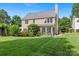 Lush backyard featuring beautiful landscaping and a screened-in porch at 16018 Hollingbourne Rd, Huntersville, NC 28078