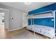 A bedroom with a metal bunk bed and a blue accent wall is shown at 16018 Hollingbourne Rd, Huntersville, NC 28078