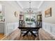 Spacious dining room with a tray ceiling, hardwood floors, and backyard views at 16018 Hollingbourne Rd, Huntersville, NC 28078