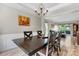 Elegant dining room with a large table, chandelier, and wainscoting at 16018 Hollingbourne Rd, Huntersville, NC 28078