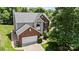Charming two-story home with brick and siding exterior, attached garage, and mature landscaping at 16018 Hollingbourne Rd, Huntersville, NC 28078