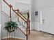 Bright foyer with hardwood floors, a staircase, and a decorative plant at 16018 Hollingbourne Rd, Huntersville, NC 28078
