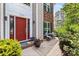 Inviting front entrance with a red door, brick pathway, and decorative landscaping at 16018 Hollingbourne Rd, Huntersville, NC 28078