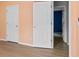 Hallway with light peach walls, white doors, and views of a blue bedroom at 16018 Hollingbourne Rd, Huntersville, NC 28078