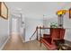 This hallway shows a chair and staircase featuring hardwood floors and natural light at 16018 Hollingbourne Rd, Huntersville, NC 28078