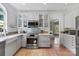 Bright kitchen with white cabinetry, stainless steel appliances, and hardwood flooring at 16018 Hollingbourne Rd, Huntersville, NC 28078