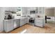 Bright kitchen with white cabinetry, stainless steel appliances, and hardwood flooring at 16018 Hollingbourne Rd, Huntersville, NC 28078