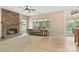 Cozy living room with stone fireplace, hardwood flooring, and comfortable seating at 16018 Hollingbourne Rd, Huntersville, NC 28078