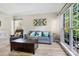 Comfortable living room with large windows, wood floors, and modern furniture at 16018 Hollingbourne Rd, Huntersville, NC 28078