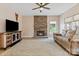 Cozy living room with stone fireplace, hardwood flooring, and comfortable seating at 16018 Hollingbourne Rd, Huntersville, NC 28078