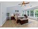 This main bedroom features high ceilings, large windows, a ceiling fan, and hardwood floors at 16018 Hollingbourne Rd, Huntersville, NC 28078