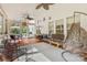 Spacious sunroom with wood floors, hanging chair, and an array of windows for natural light at 16018 Hollingbourne Rd, Huntersville, NC 28078