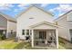 Home's backyard featuring a screened-in porch and well-maintained lawn at 16018 River Tree Ln, Charlotte, NC 28278