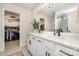 Double sink bathroom with walk-in closets and shower featuring matte black fixtures and hardware at 16018 River Tree Ln, Charlotte, NC 28278