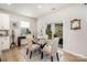 Elegant dining room with a glass table, four chairs, and access to the outdoor patio at 16018 River Tree Ln, Charlotte, NC 28278