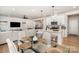 Open-concept dining area with a glass table, four chairs, and easy access to kitchen and living area at 16018 River Tree Ln, Charlotte, NC 28278