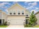Charming two-story home with a two-car garage, well-maintained lawn, and beautiful curb appeal under a bright, sunny sky at 16018 River Tree Ln, Charlotte, NC 28278