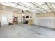Spacious garage featuring a sink, peg board, storage shelves and ample room for vehicles at 16018 River Tree Ln, Charlotte, NC 28278