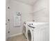 Convenient laundry room with modern washer and dryer, shelving for storage, and neutral tones at 16018 River Tree Ln, Charlotte, NC 28278