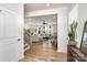 Bright, open-concept living space with hardwood floors and modern furnishings viewed from entry at 16018 River Tree Ln, Charlotte, NC 28278