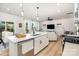 Open floor plan connects kitchen, dining, and living areas with white walls and wood-look floors at 16018 River Tree Ln, Charlotte, NC 28278