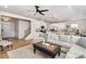 Open-concept living space featuring a white kitchen, inviting living area, and stairs at 16018 River Tree Ln, Charlotte, NC 28278