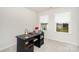Bright office space featuring a dark desk and two windows at 16018 River Tree Ln, Charlotte, NC 28278