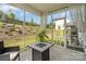 Screened-in porch, featuring a table and chairs overlooking the lawn at 16018 River Tree Ln, Charlotte, NC 28278