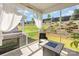 Charming screened porch with sheer curtains and a view of the backyard's tiered landscaping at 16018 River Tree Ln, Charlotte, NC 28278
