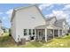 Rear exterior view highlights the screened porch and the adjacent grassy yard at 16018 River Tree Ln, Charlotte, NC 28278