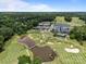 Aerial view of golf course, clubhouse, and surrounding woods and neighborhood at 16028 Cranleigh Dr, Huntersville, NC 28078